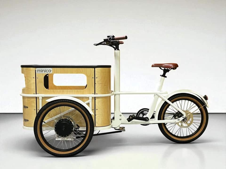 Side profile of the minica electric cargo trike showing frame and battery.