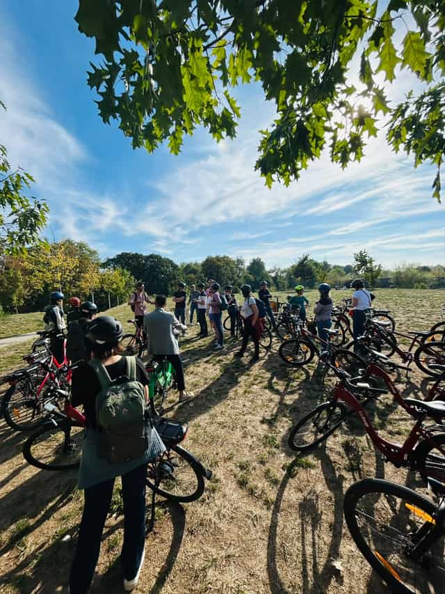 Group of riders and bicycles gathered in a park
