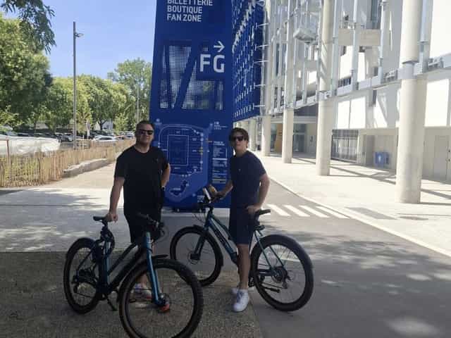Père et fils avec leurs vélos devant le stade de la Meinau