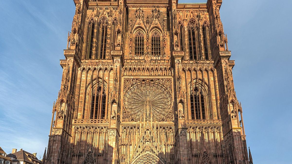La cathédrale de Strasbourg illuminée à l'heure bleue au-dessus des toits de la vieille ville
